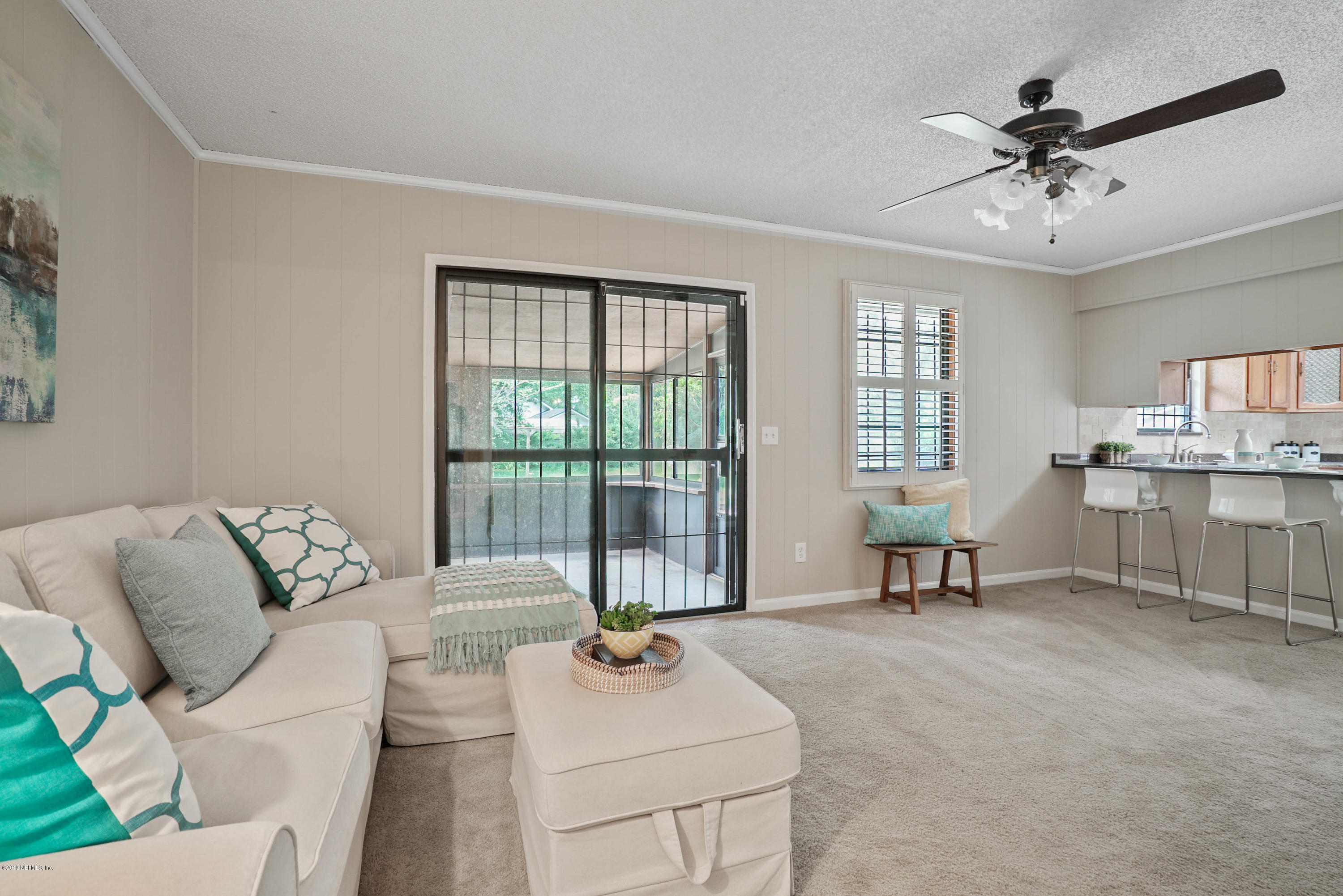 5353 Hickson Road Jacksonville, FL 32207 - Photo 6 of 18 a living room with furniture and floor to ceiling windows