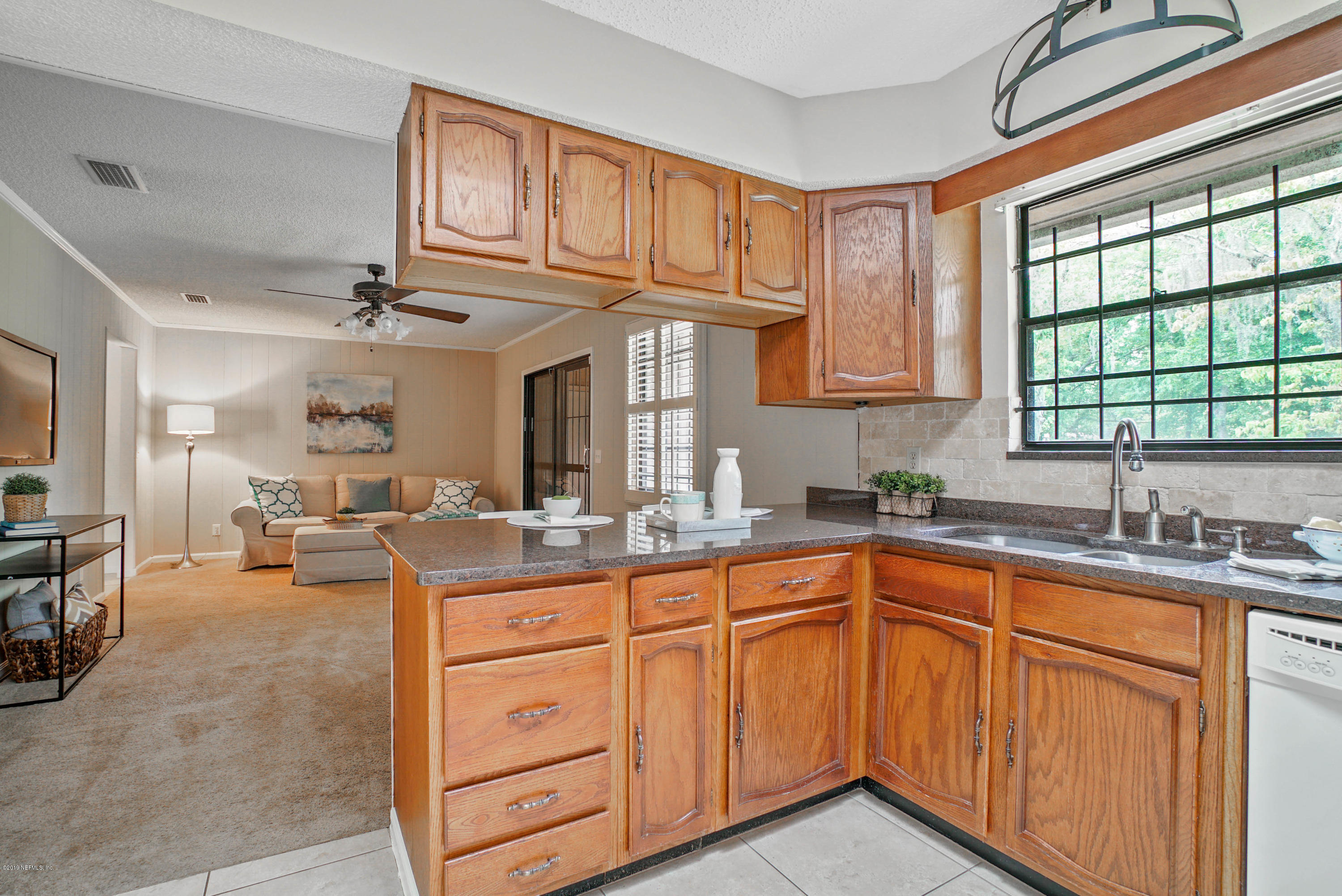 5353 Hickson Road Jacksonville, FL 32207 - Photo 9 of 18 a kitchen with sink stove and cabinets