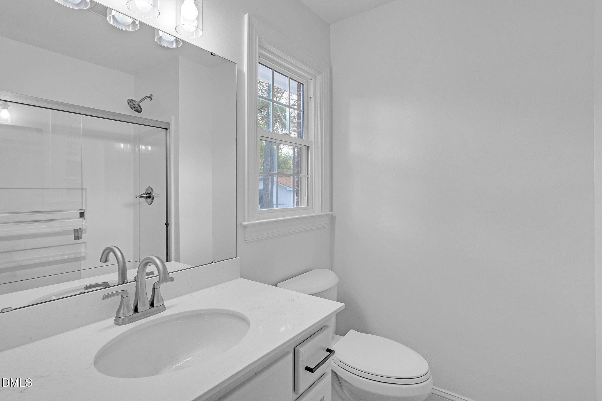 1219 Queen Anne Road Northwest Wilson, NC 27896 - Photo 11 of 26 a bathroom with a sink a toilet and shower