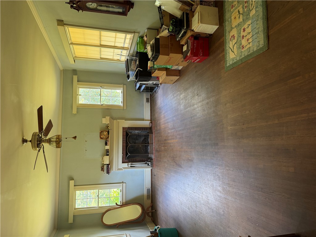715 Concord Road Anderson, SC 29621 - Photo 15 of 24 A classic fireplace with a detailed mantel serves as the focal point in this room with hardwood flooring.