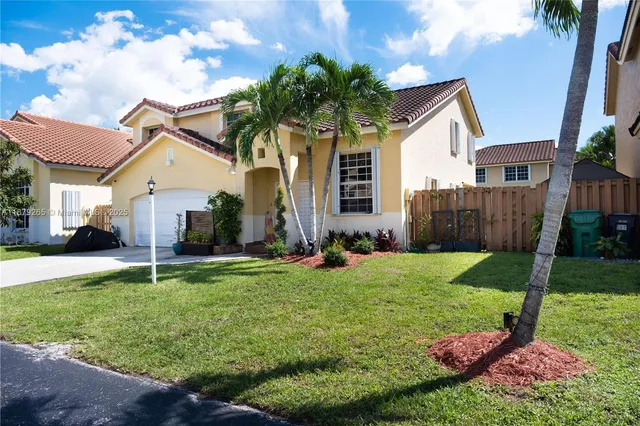 a house that has a big yard and large trees