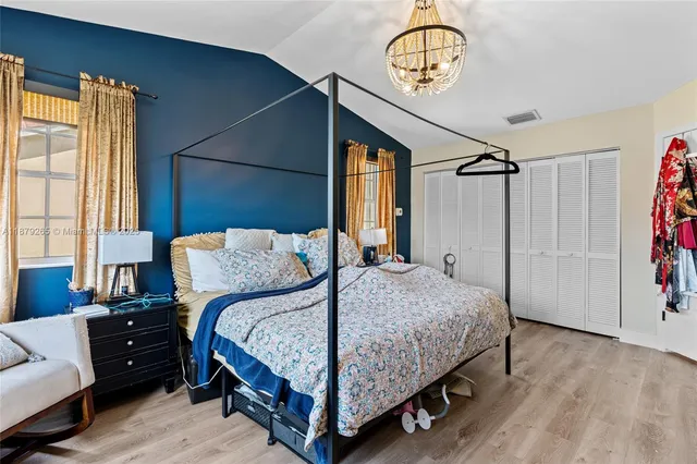 a bedroom with a bed mirror and a window