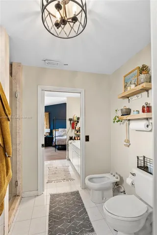 a bathroom with a granite countertop sink a toilet and a mirror