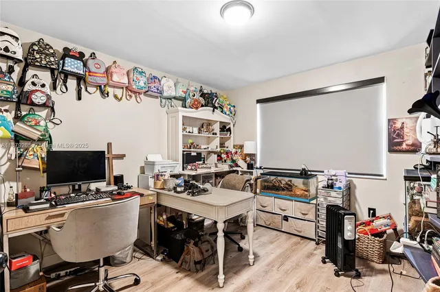 a view of a workspace with furniture and a flat screen tv