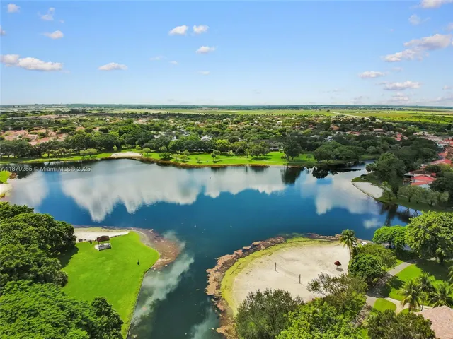an aerial view of a houses with a lake view