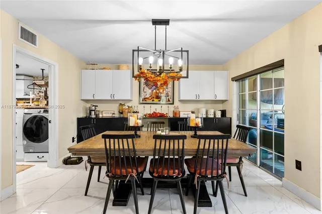 a view of a dining room with furniture and chandelier