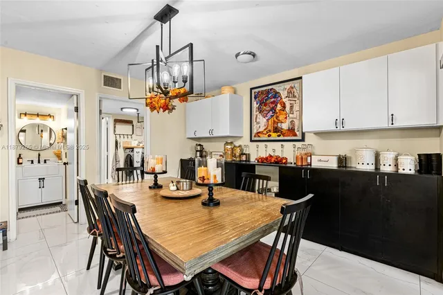 a view of a dining room with furniture wooden floor and chandelier