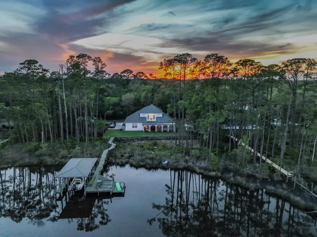 a view of a lake with table and chairs