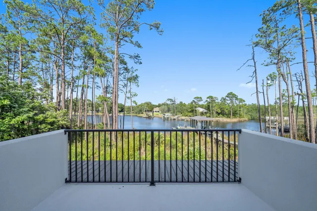 a view of a patio with lawn chairs next to a yard