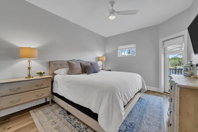 an aerial view of ocean and residential houses with outdoor space