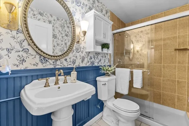 a bathroom with a sink a toilet and shower curtain