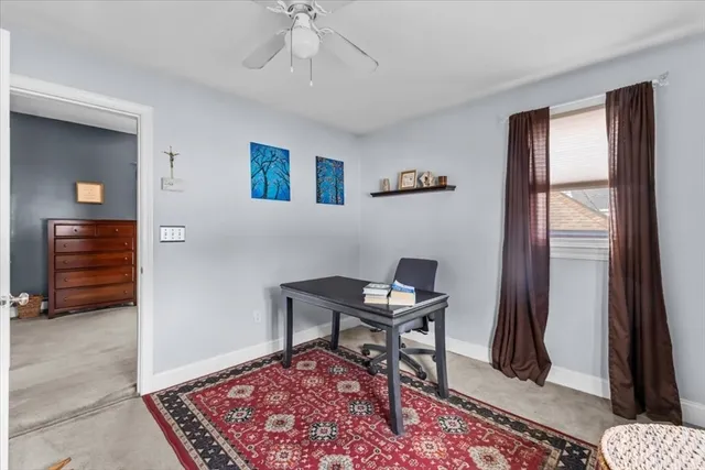 a workspace with wooden floor and a rug