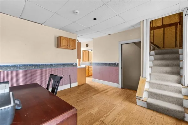 a view of staircase with wooden floor and chair