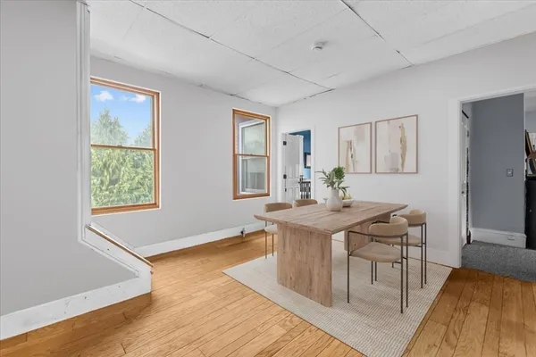 a view of a dining room with furniture window and wooden floor