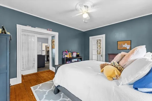 a bedroom with a bed and wooden floor