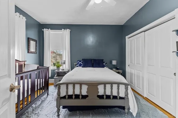 a bedroom with a bed with window