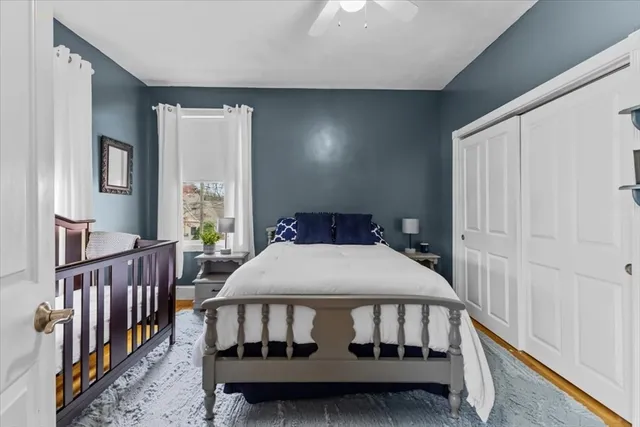 a bedroom with a bed with window