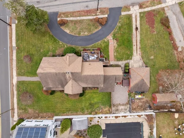 an aerial view of a house with garden space and lake view