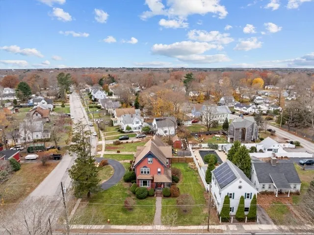 an aerial view of residential houses with city view