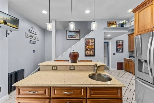 a kitchen with a sink and a refrigerator