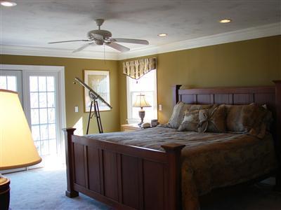 Undisclosed Address Dennis, MA 02638 - Photo 16 of 29 a bed room with a bed and a chandelier