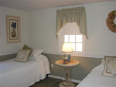Undisclosed Address Dennis, MA 02638 - Photo 18 of 29 a bedroom with a bed and a table