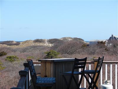 Undisclosed Address Dennis, MA 02638 - Photo 21 of 29 a view of a balcony with furniture and a mountain