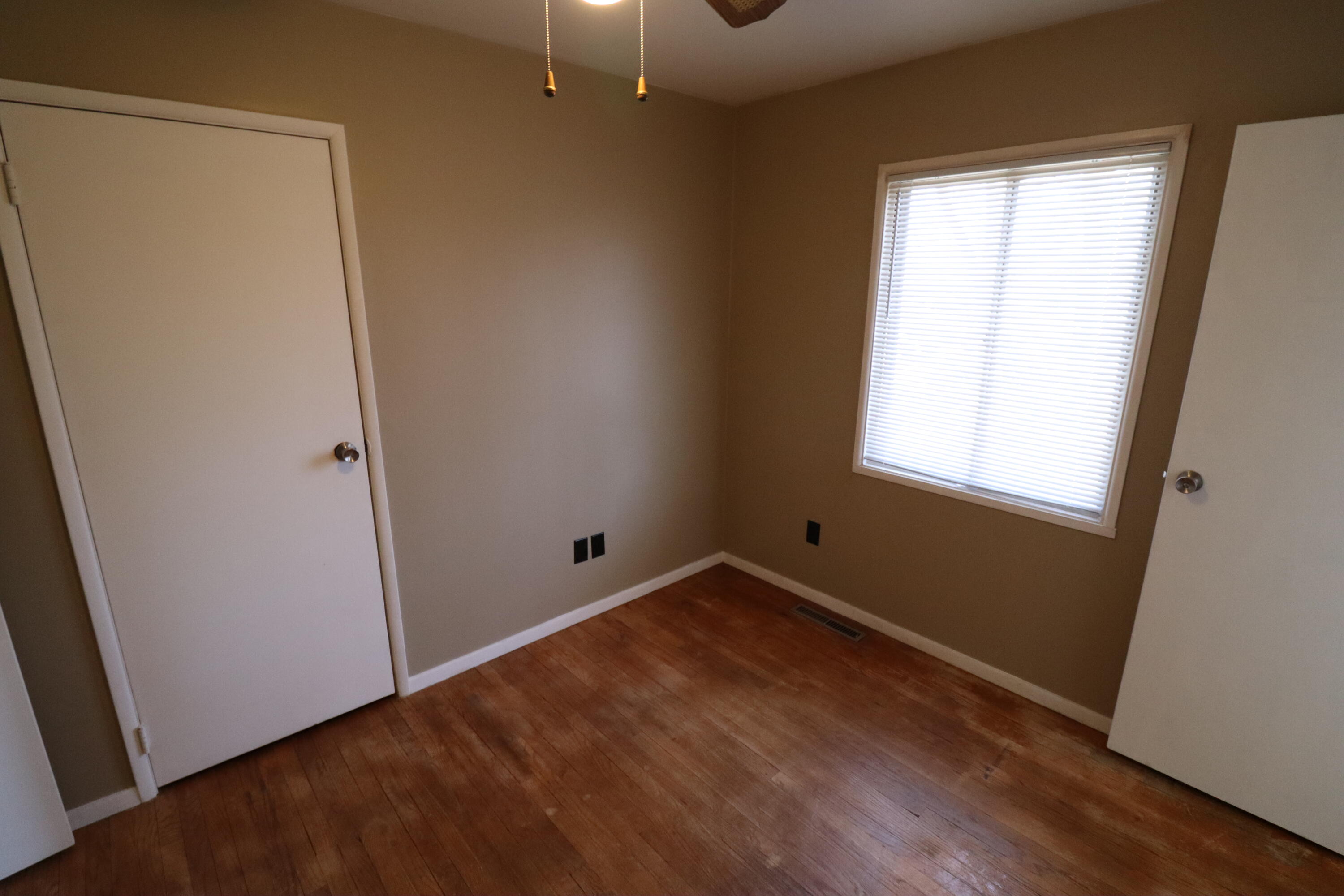 3867 South Liverpool Road Hobart, IN 46342 - Photo 11 of 27 an empty room with wooden floor and windows
