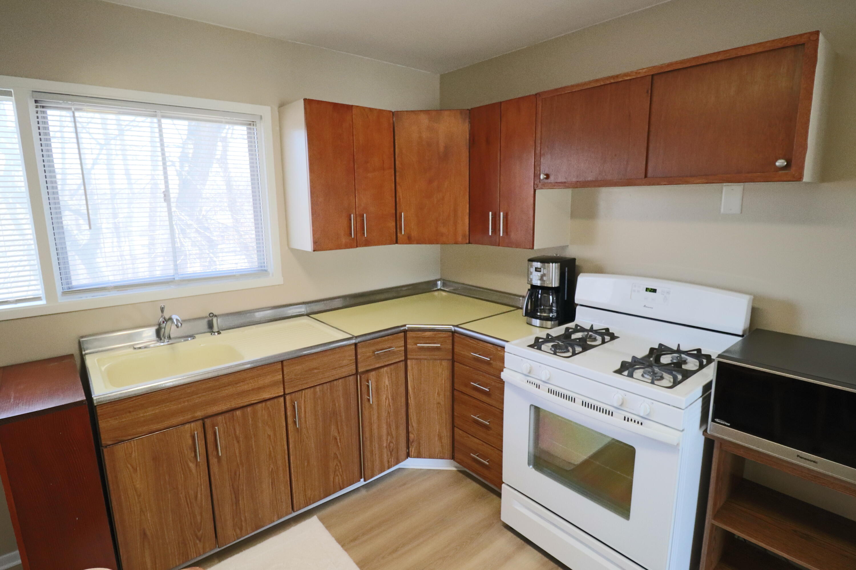 3867 South Liverpool Road Hobart, IN 46342 - Photo 8 of 27 a kitchen with a sink stove and cabinets