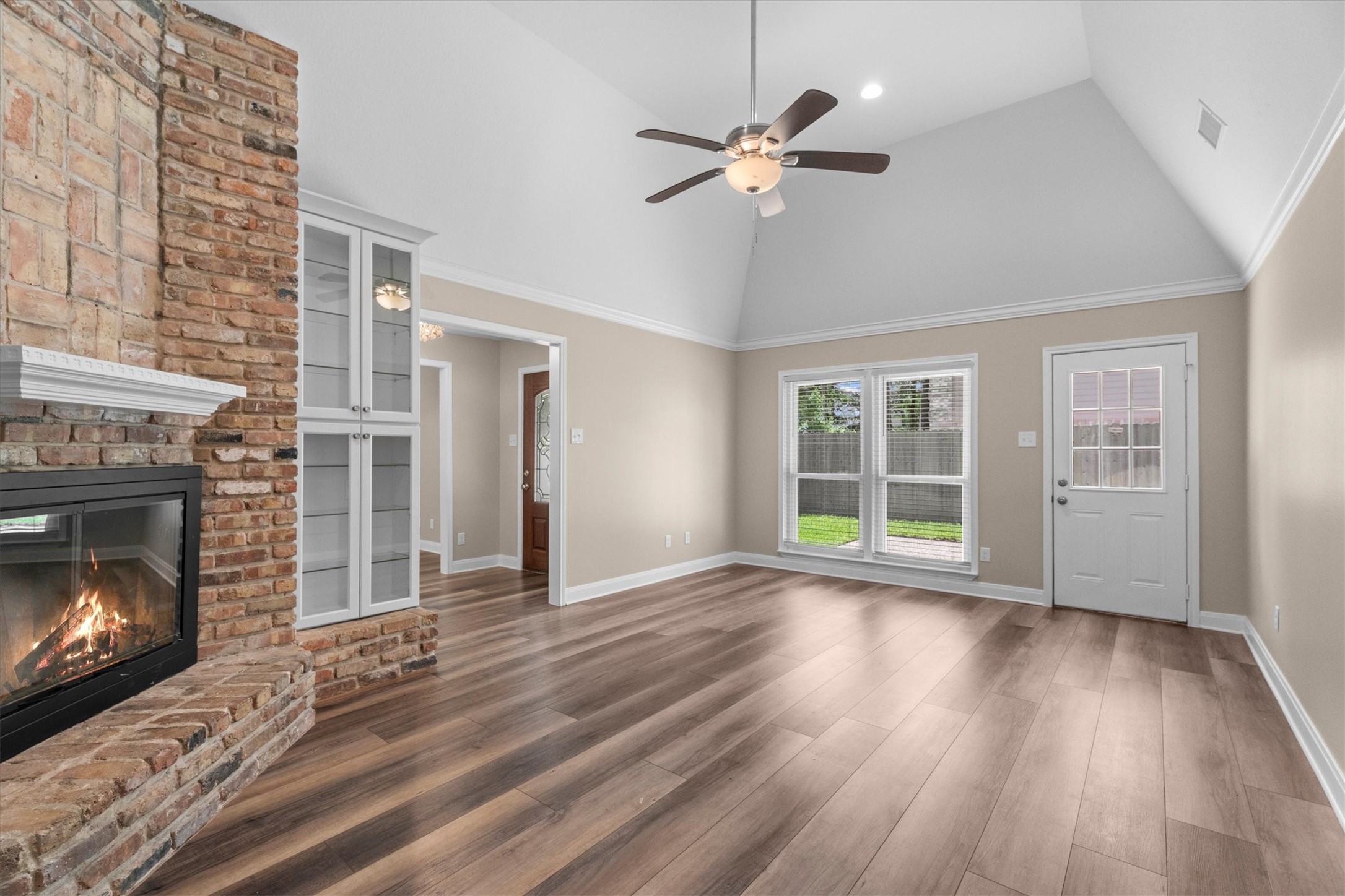 6530 Bayonne Drive Spring, TX 77389 - Photo 21 of 37 a view of an empty room with wooden floor fireplace and a window
