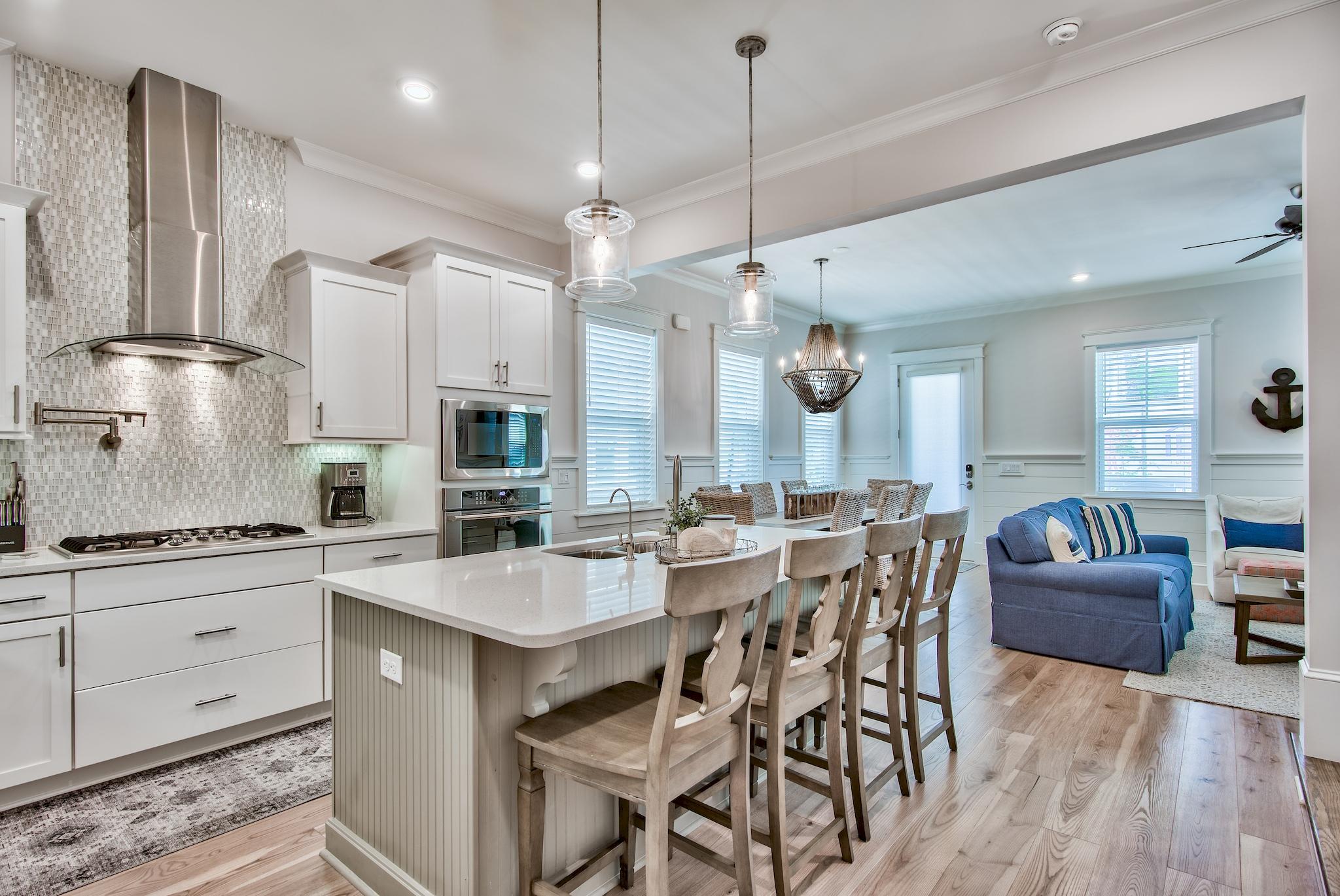 75 Siasconset Ln Inlet Beach Inlet Beach, FL 32461 - Photo 8 of 64 a large kitchen with stainless steel appliances kitchen island granite countertop a stove a sink a dining table and chairs with wooden floor