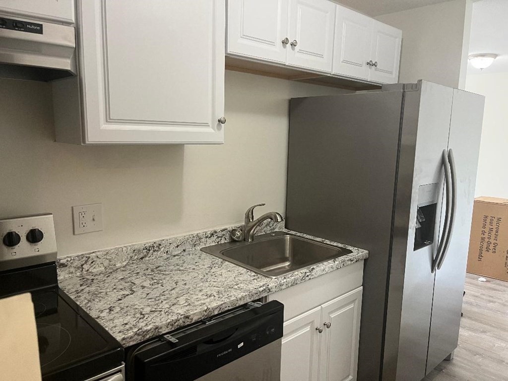 800 County Street, Unit 20 Taunton, MA 02780 - Photo 2 of 19 a kitchen with stainless steel appliances granite countertop a sink stove and refrigerator