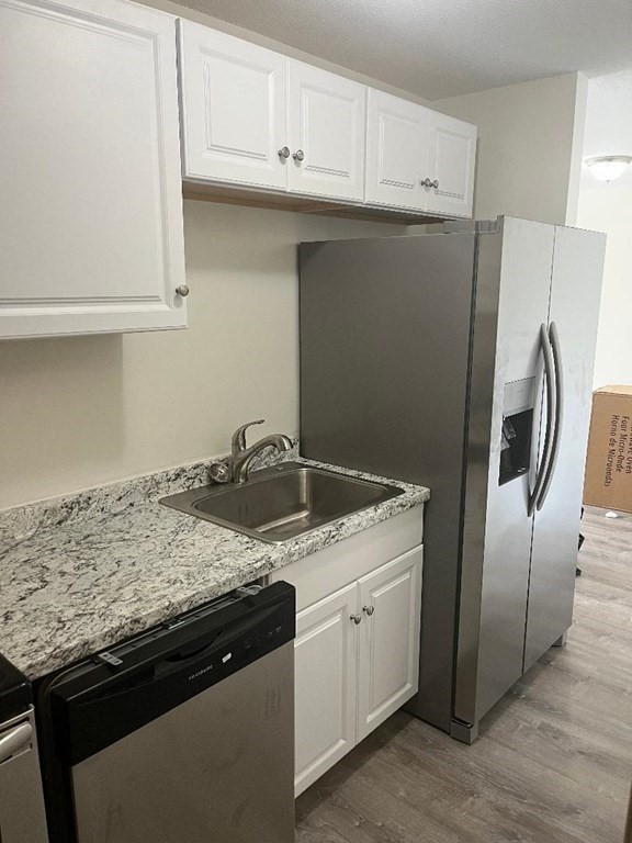 800 County Street, Unit 20 Taunton, MA 02780 - Photo 3 of 19 a kitchen with granite countertop a refrigerator sink and cabinets