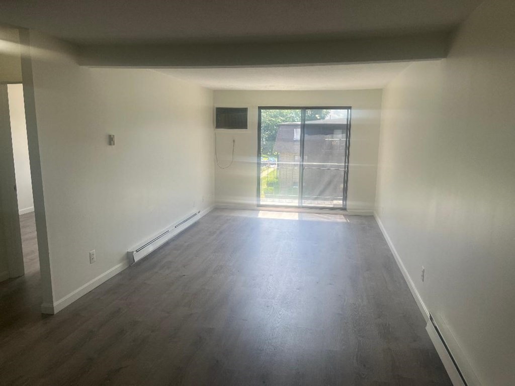 800 County Street, Unit 20 Taunton, MA 02780 - Photo 6 of 19 an empty room with wooden floor and windows