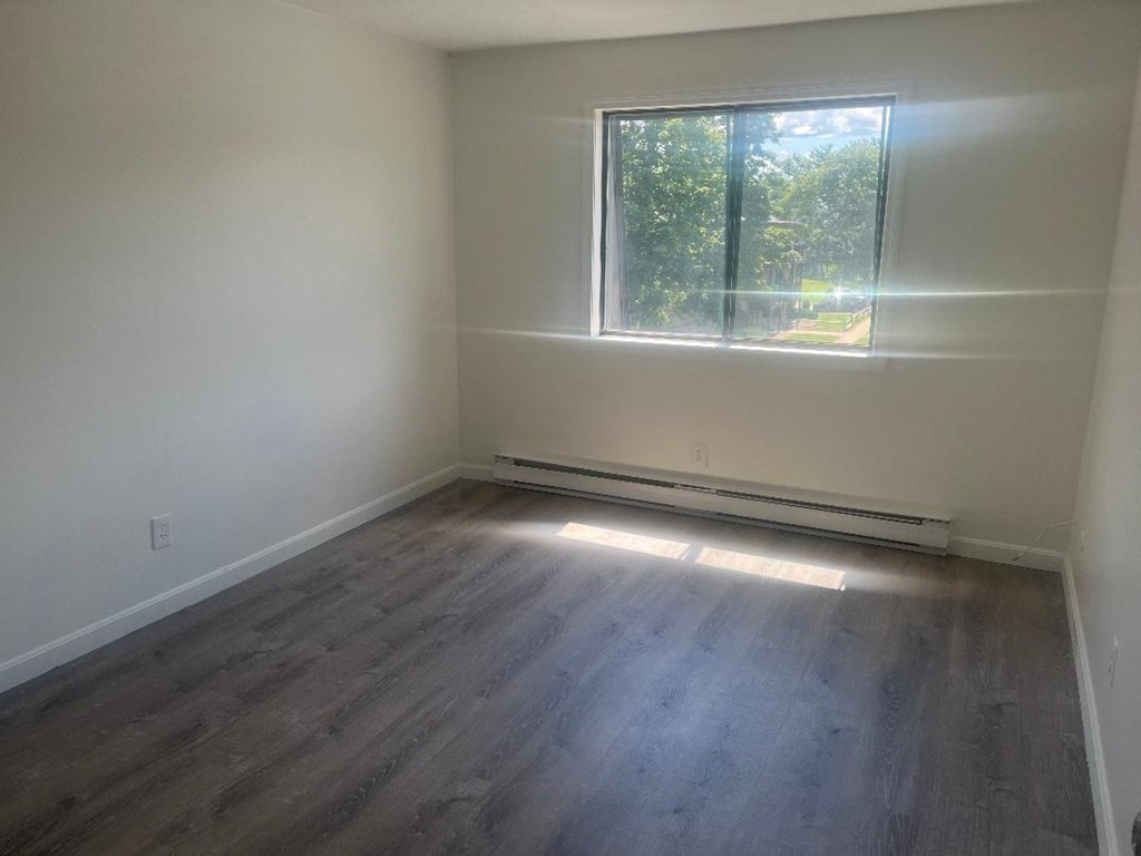 800 County Street, Unit 20 Taunton, MA 02780 - Photo 9 of 19 an empty room with wooden floor and windows