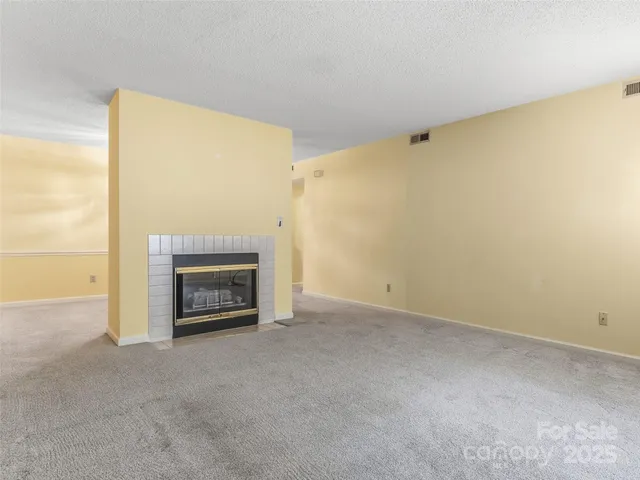 a view of an empty room with a fireplace