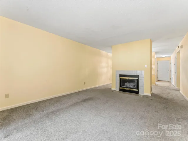 a view of an empty room with a fireplace