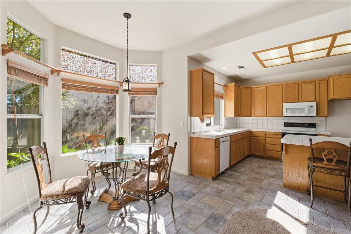 1903 Alex Way Turlock, CA 95382 - Photo 14 of 40 a kitchen with a window a sink and chairs