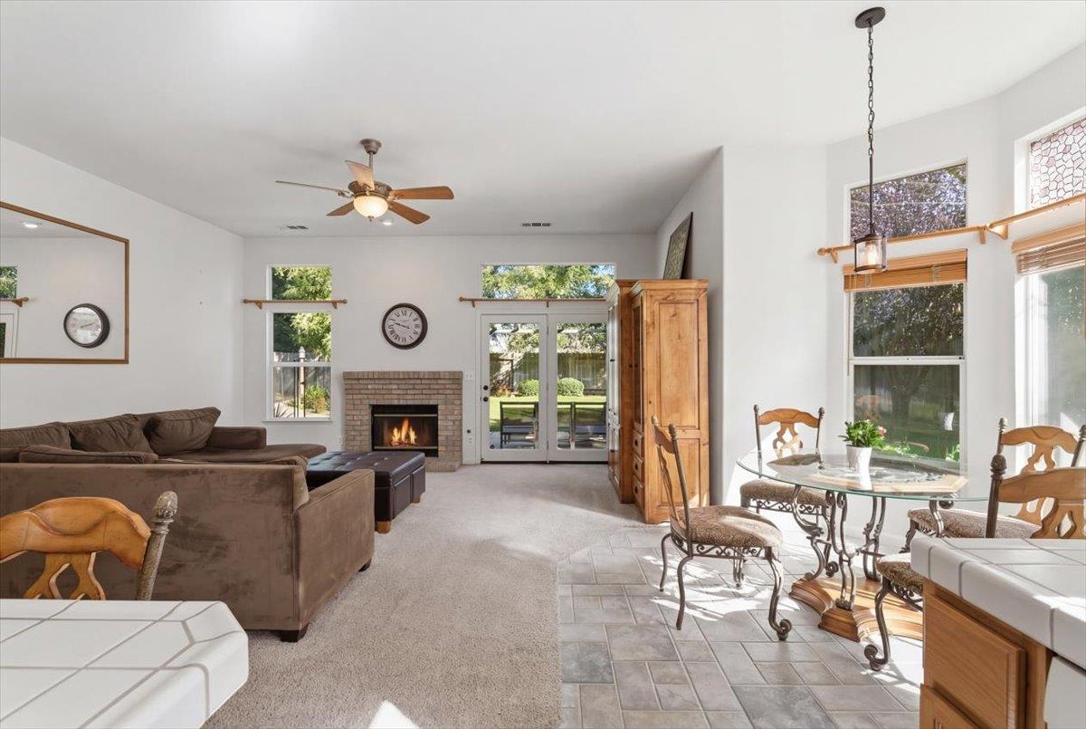 1903 Alex Way Turlock, CA 95382 - Photo 15 of 40 a living room with furniture a fireplace and a large window