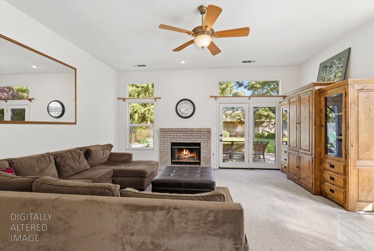 1903 Alex Way Turlock, CA 95382 - Photo 16 of 40 a living room with furniture a fireplace and a large window