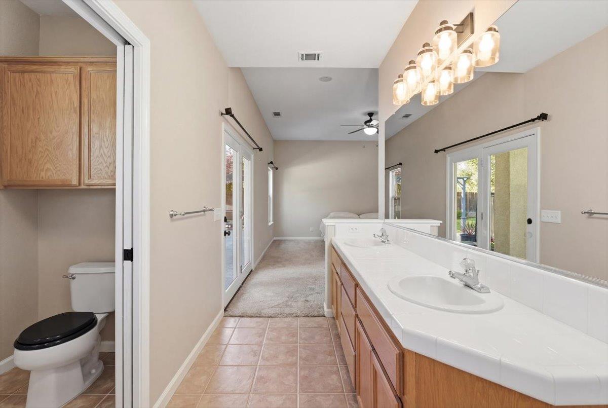 1903 Alex Way Turlock, CA 95382 - Photo 23 of 40 a bathroom with a tub sink and mirror