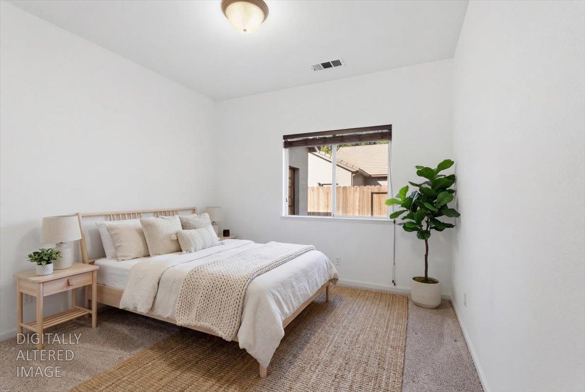 1903 Alex Way Turlock, CA 95382 - Photo 24 of 40 a bedroom with a bed and a potted plant