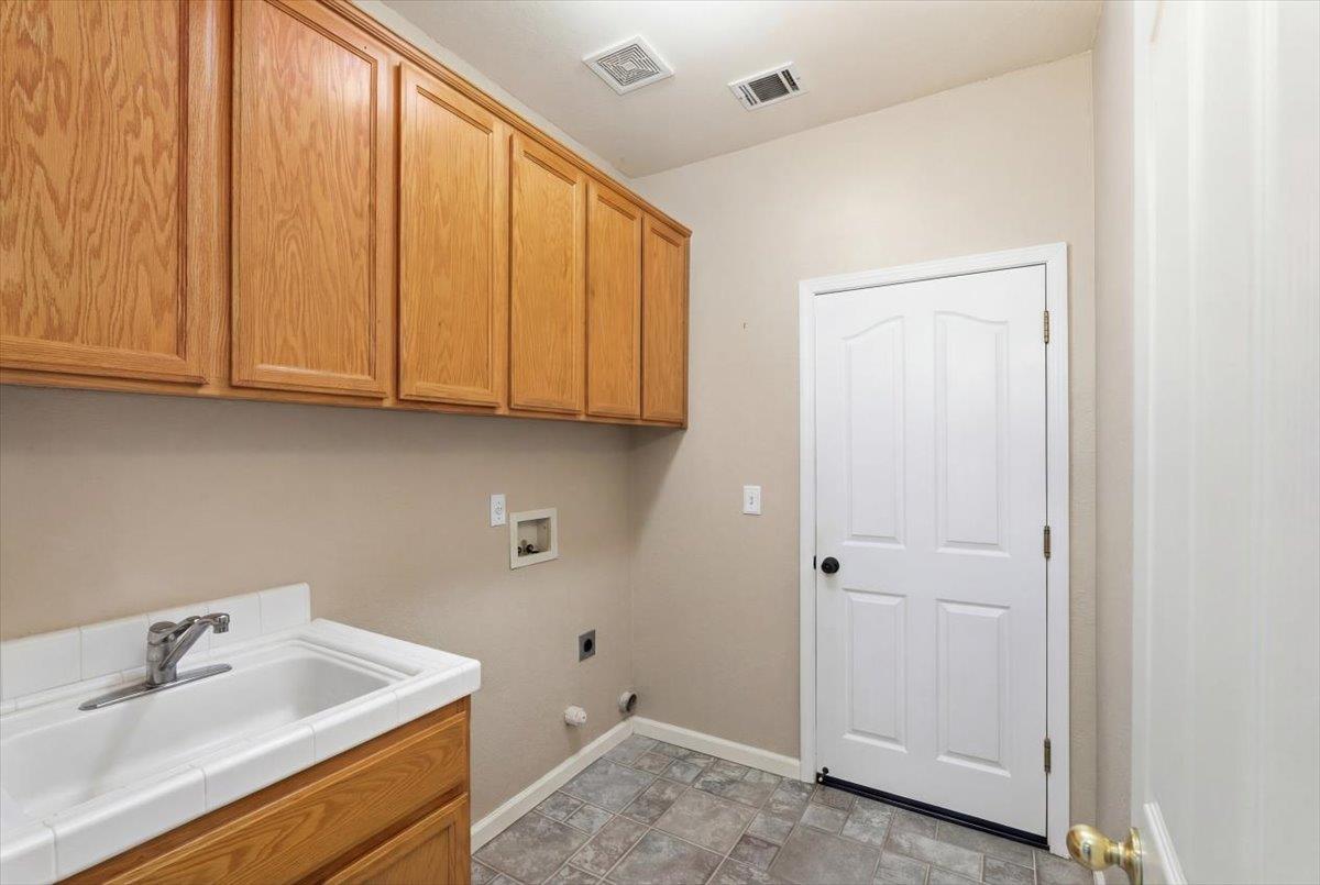 1903 Alex Way Turlock, CA 95382 - Photo 27 of 40 a bathroom with a sink and cabinets