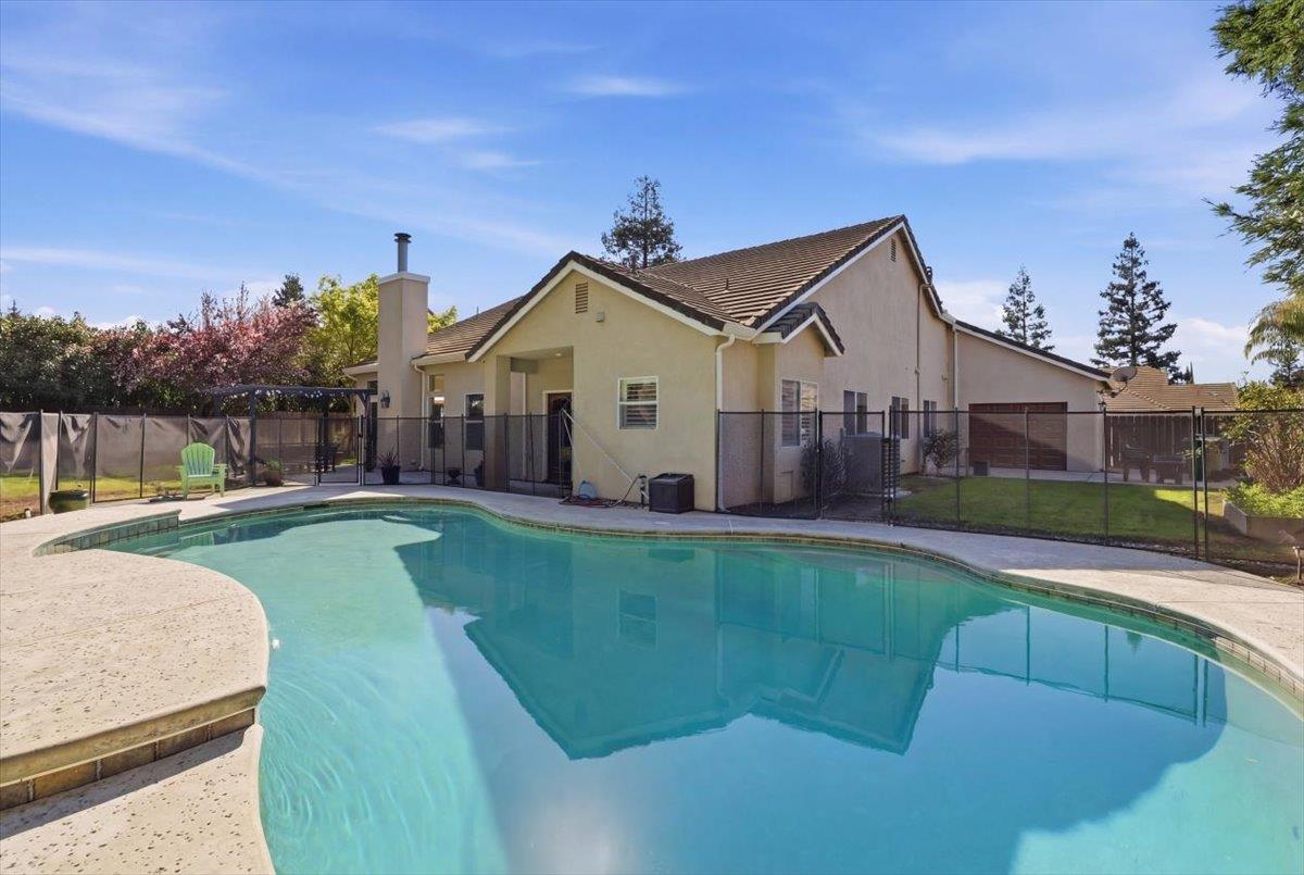 1903 Alex Way Turlock, CA 95382 - Photo 30 of 40 a view of a house with a big yard potted plants and a large tree