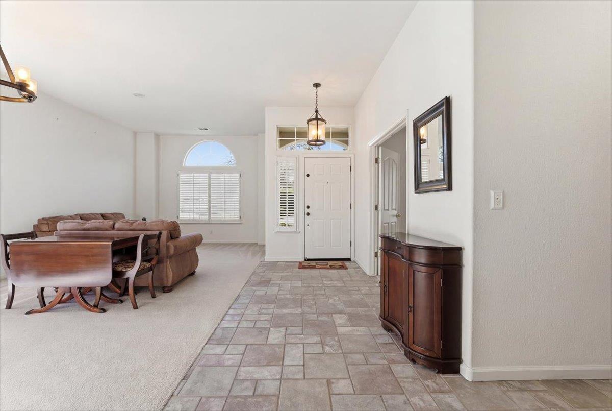 1903 Alex Way Turlock, CA 95382 - Photo 3 of 40 a view of workspace with furniture and a chandelier