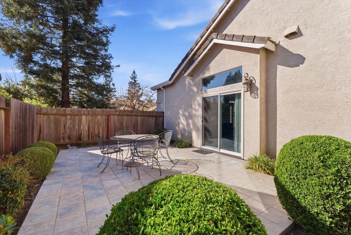 1903 Alex Way Turlock, CA 95382 - Photo 33 of 40 a view of a patio with table and chairs with wooden fence and plants