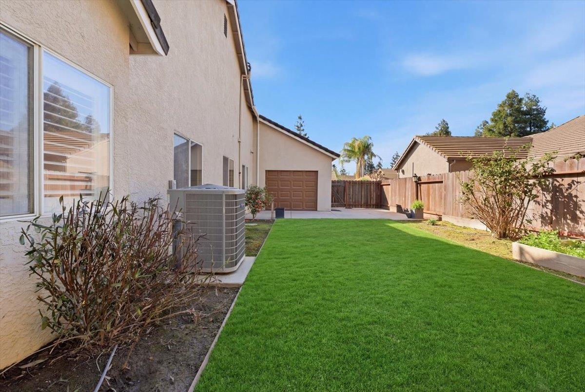1903 Alex Way Turlock, CA 95382 - Photo 35 of 40 a view of a house with brick walls and a yard with plants