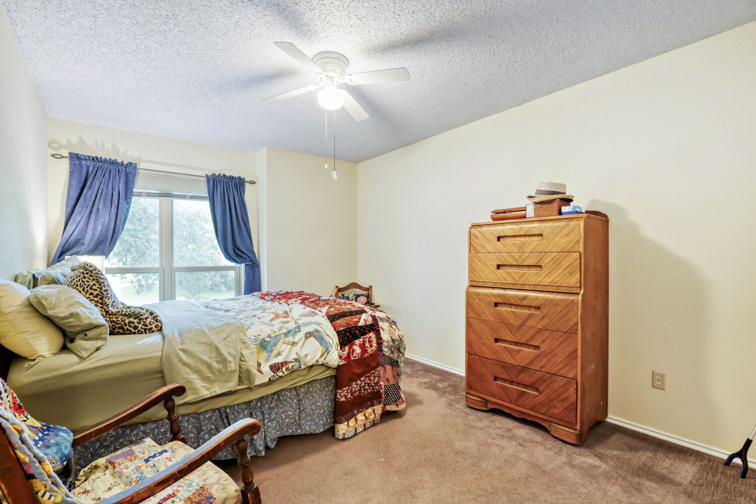 13129 New Boston Bend Austin, TX 78729 - Photo 14 of 26 Bedroom featuring light carpet, a textured ceiling, and a ceiling fan