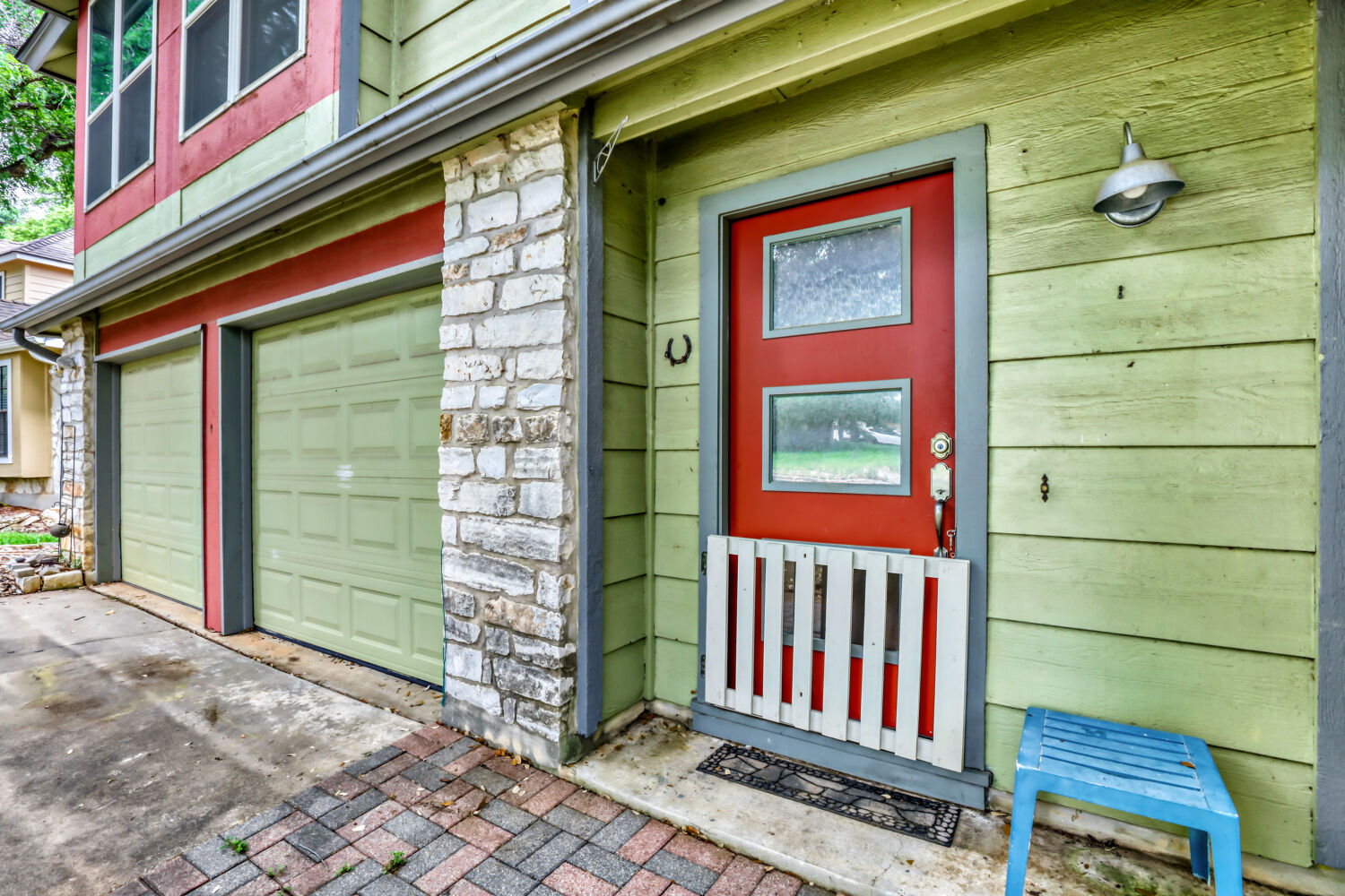 13129 New Boston Bend Austin, TX 78729 - Photo 2 of 26 Doorway to property featuring stone siding, a garage, and driveway