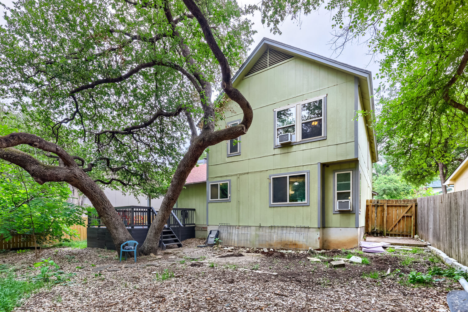 13129 New Boston Bend Austin, TX 78729 - Photo 22 of 26 Back of house with a fenced backyard, a wooden deck, and a gate